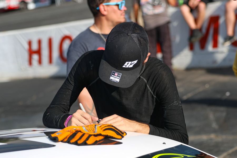 Jonah signing an autograph