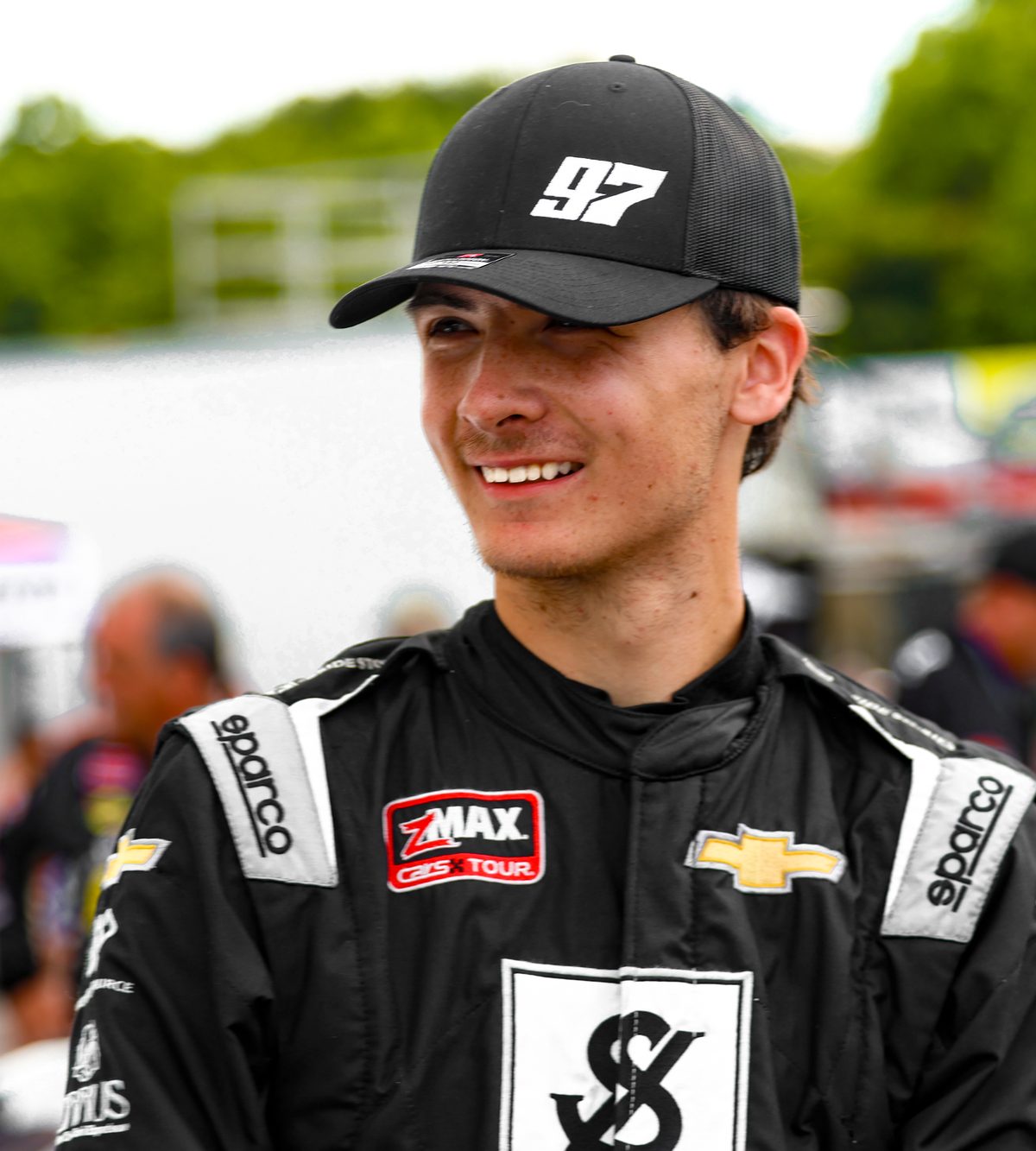 Jonah Cullen smiling in his #97 hat and firesuit