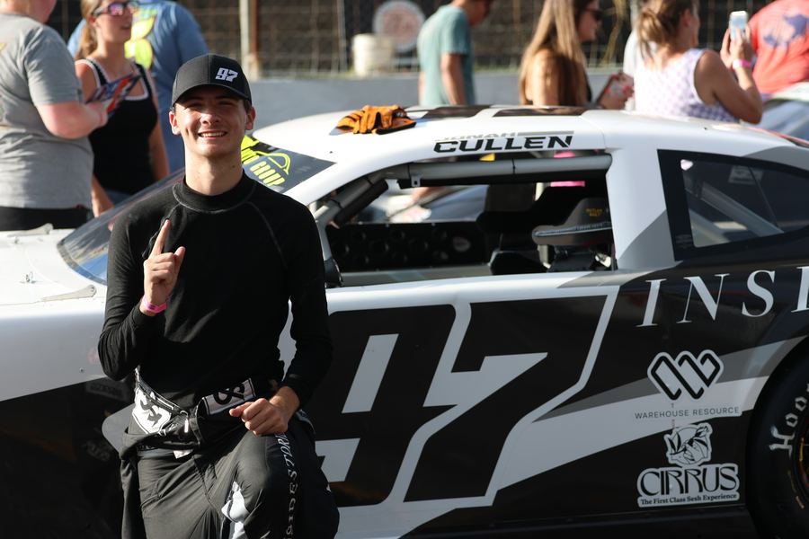 Jonah pointing a number-one finger beside the #97